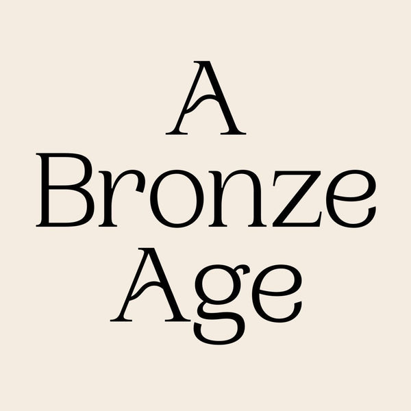 A Bronze Age black serif text on beige background, minimalist logo design